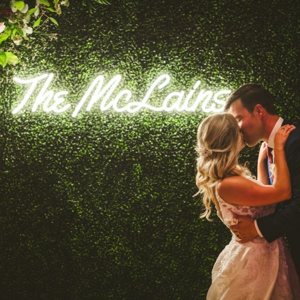 flower wall photo booth backdrop with neon sign
