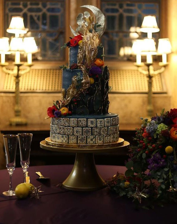 gothic black and gold cake with wedding decor