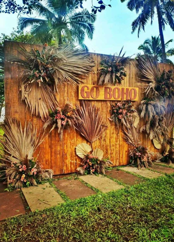 rustic inspired boho photo booth with palm leaves