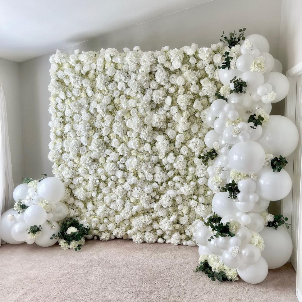 white balloons on a flower wall wedding backdrop
