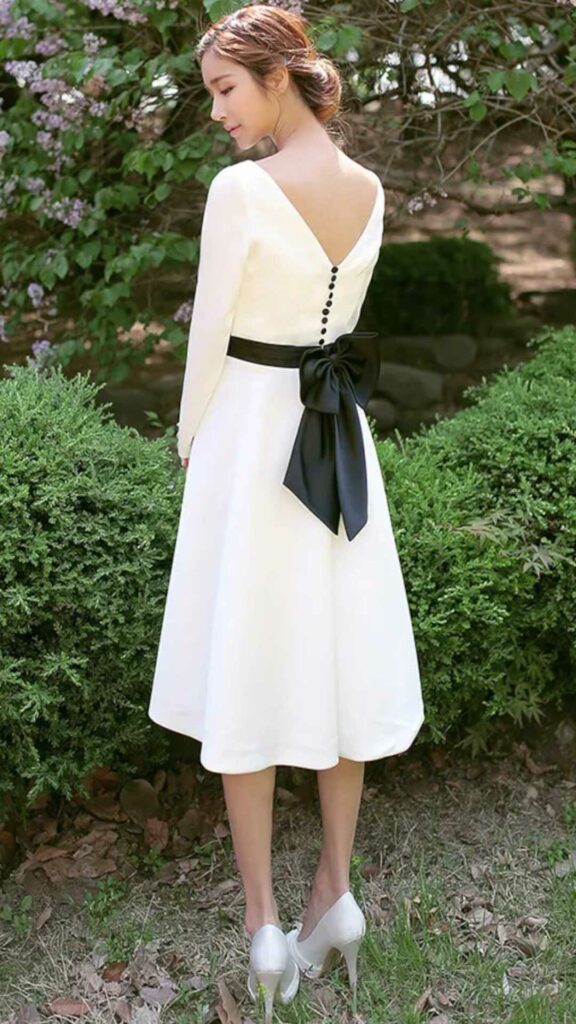 simple black and white tea length wedding dress with back button