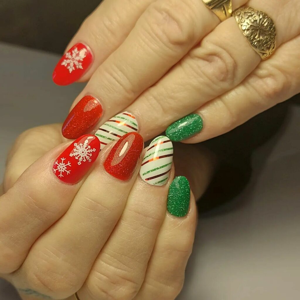 Christmas red and green nails sparkle with snowy snowflake accents and joyful candy cane stripes