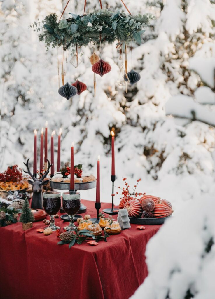 Christmas winter wedding tablescapes adorned with rich red textiles elegant candlelight and festive ornaments