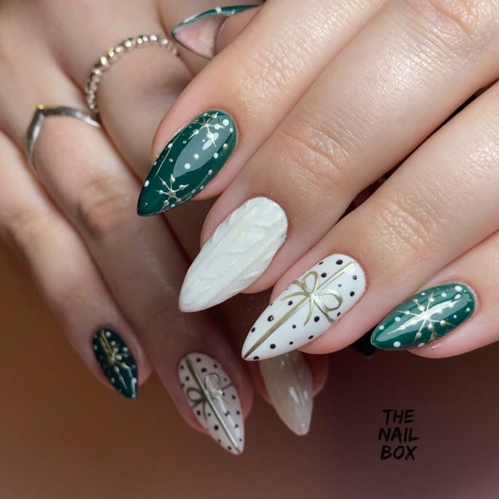 Elegant winter wonderland nail art with emerald and ivory tones
