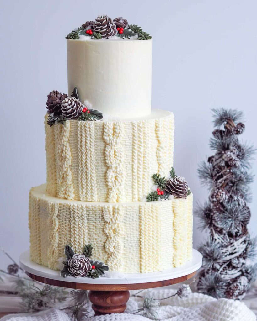 Gingerbread layer winter sweater inspired wedding cake filled with orange custard and orange cream cheese buttercream