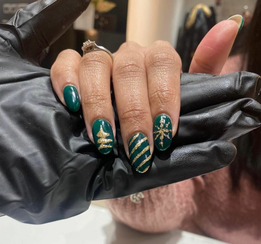Opulent emerald with golden stripe and snowflake Christmas nail art