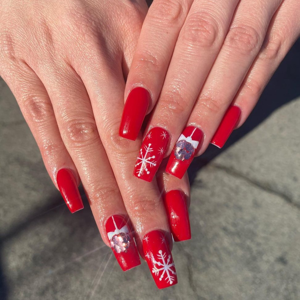 Radiant red sunlit snowflakes Christmas nails art