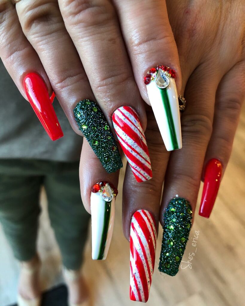Sparkling like holiday lights red and green gems adorn each nail mirroring a Christmas tree
