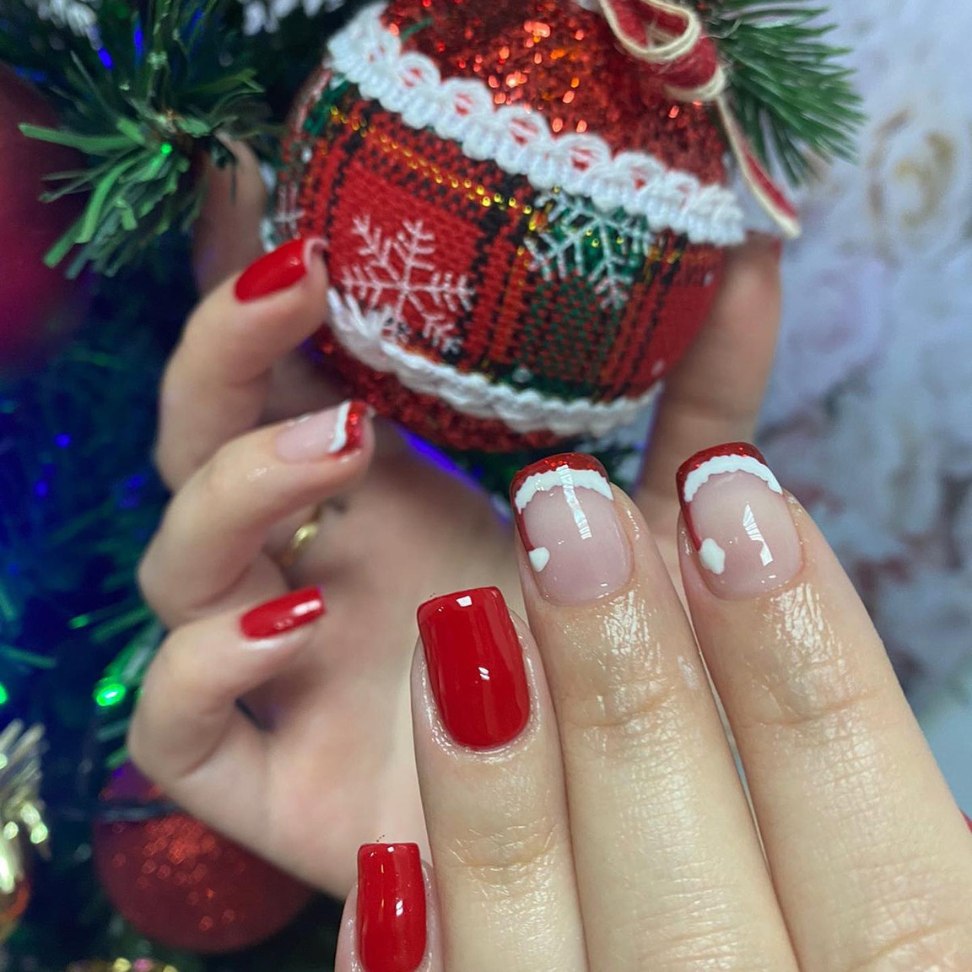 Vibrant red with snow capped French tip Christmas nails