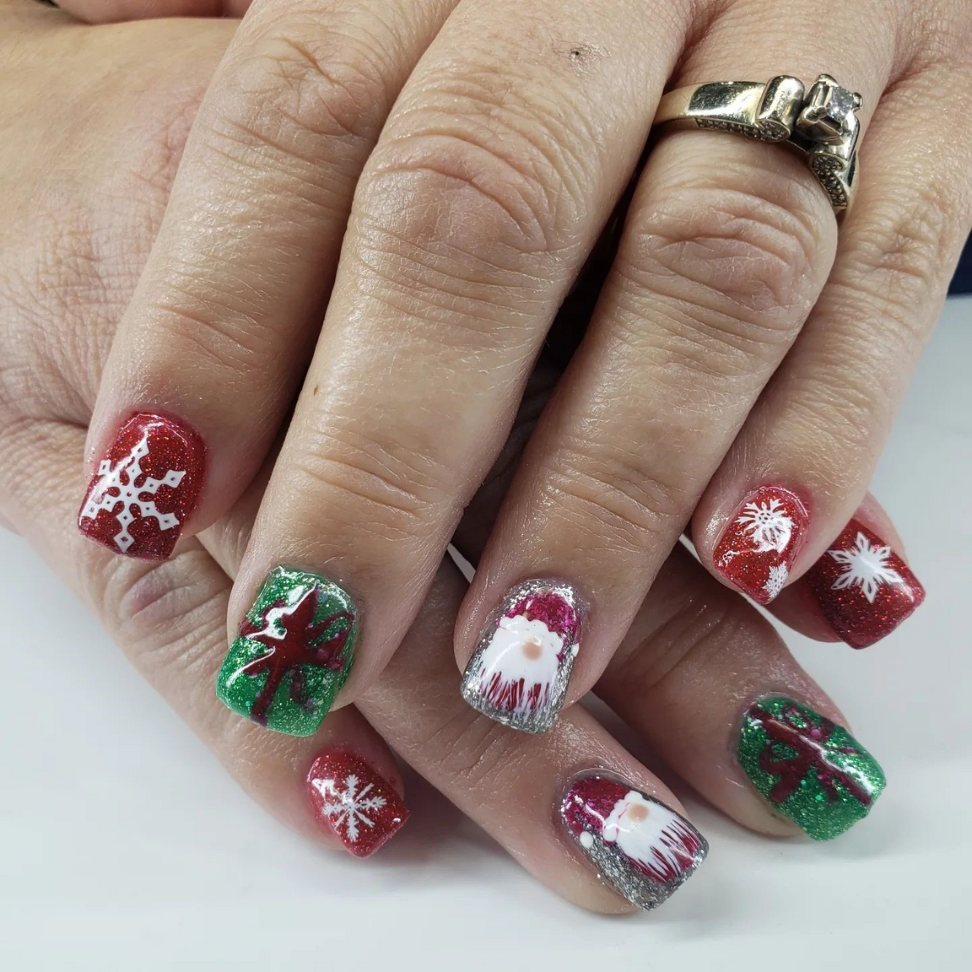 bright and cheerful red and green Christmas nails adorned with festive patterns and a touch of glitter