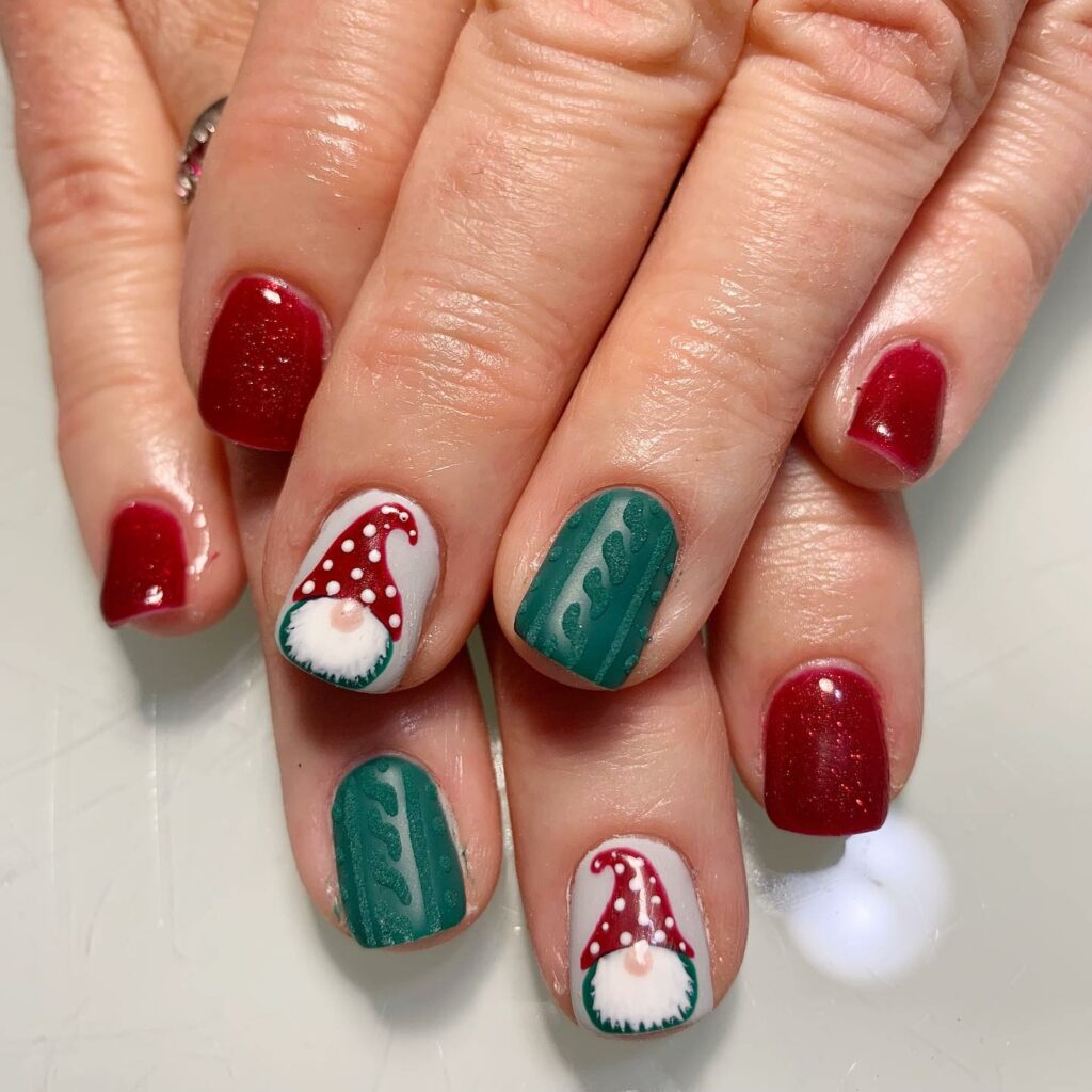 charming elf hat motifs set against the classic Christmas red and green nails