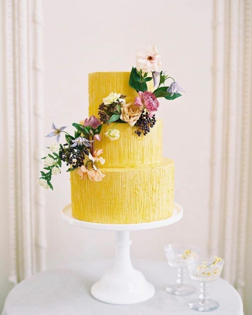 dramatic winter wedding yellow cake with flowers
