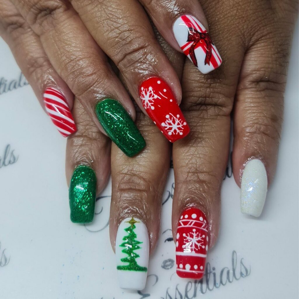 festive red and green colors Christmas nails with snowflake patterns and a decorative bow