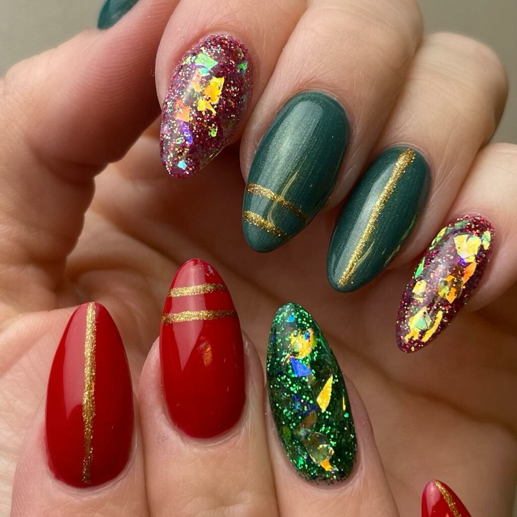 luxurious red and green Christmas nails with opulent gold accents and sparkling glitter