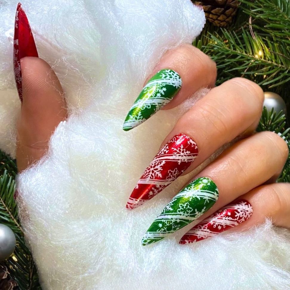 pointed shape and the delicate snowflake nails designs in classic Christmas red and green