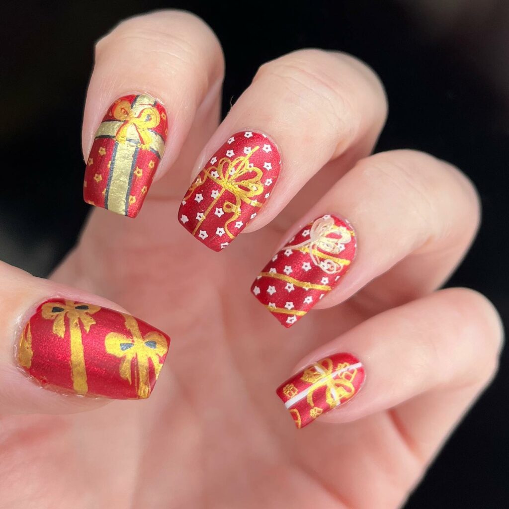 red and golden bow Christmas nails art