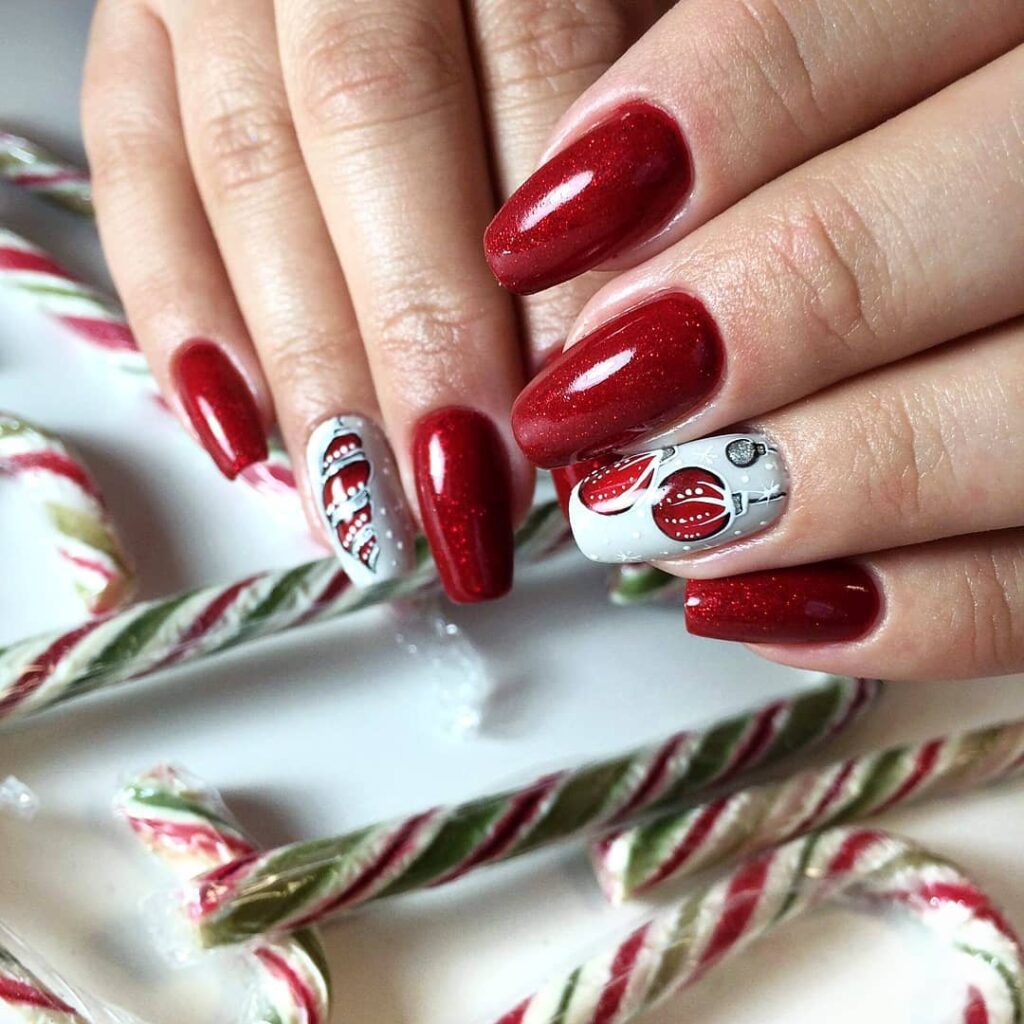 red glitter Christmas nails with holiday motifs