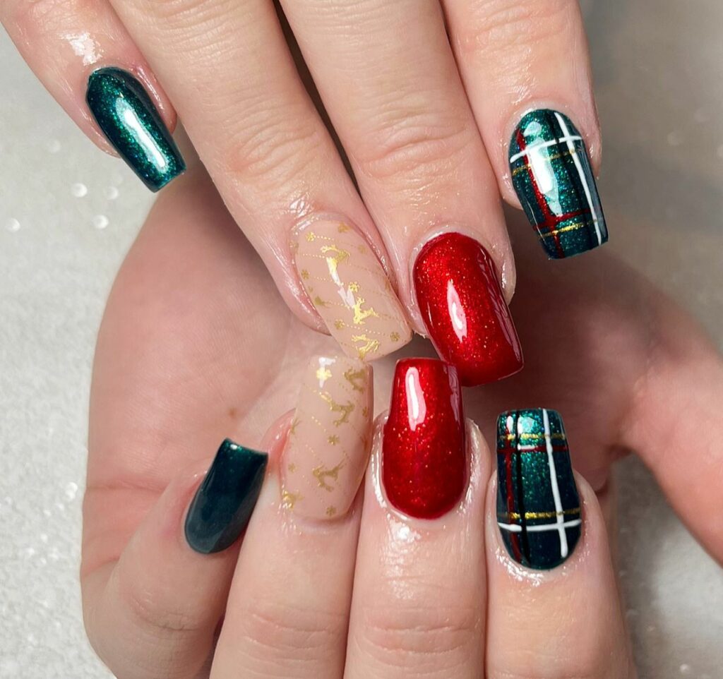 rich green tones with vibrant reds and is accented by delicate gold details Christmas nails art