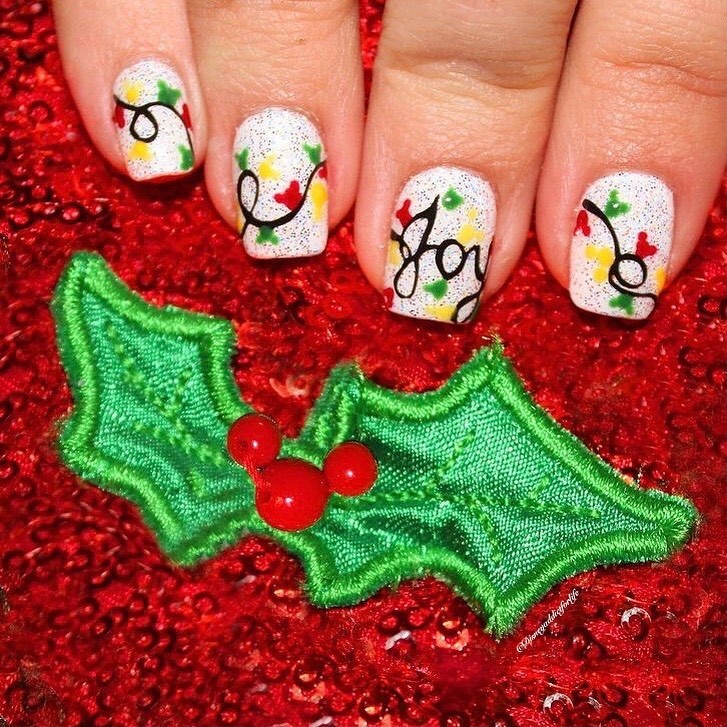 the joyful Christmas lights and the word Joy amidst a seasonal sprinkle of red and green nails
