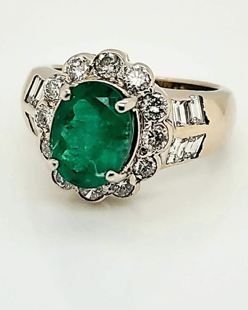vintage emerald oval engagement ring with 18 carat yellow gold