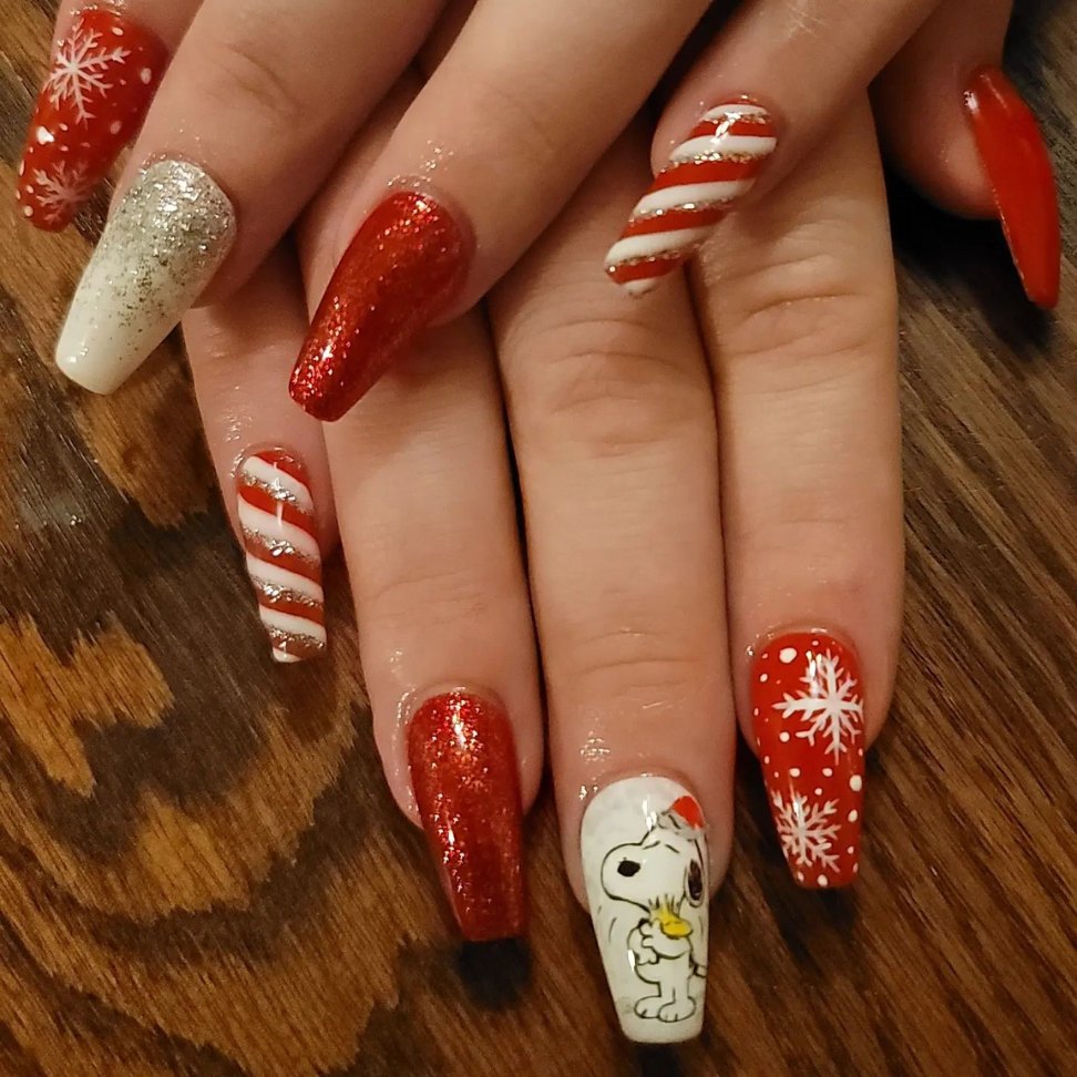 white and red snowflakes and candy cane Christmas nail design