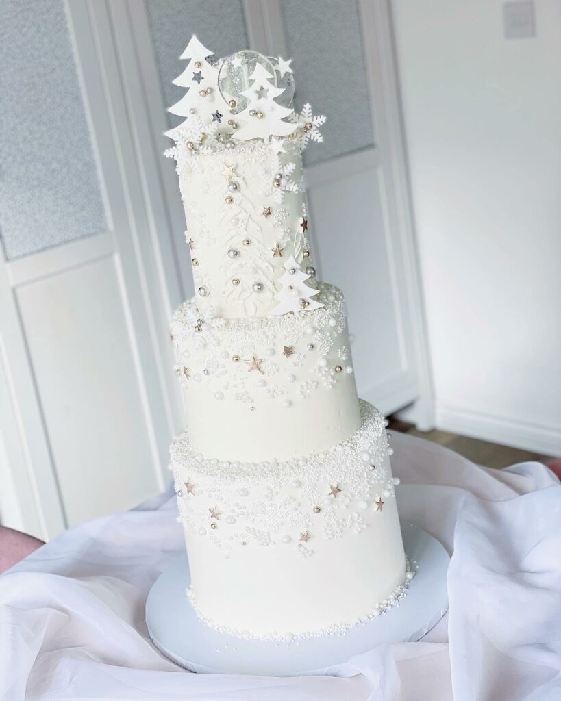 winter wonderland three tiered white wedding cake