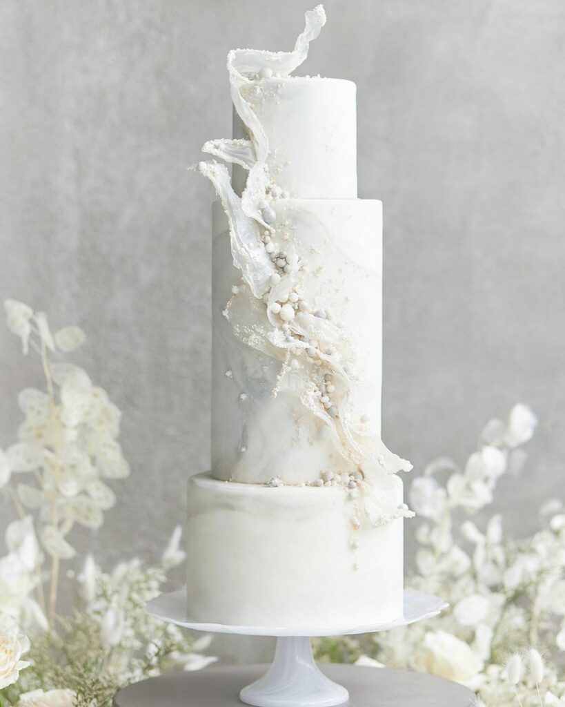 Modern pearl wedding cake with textured white accents