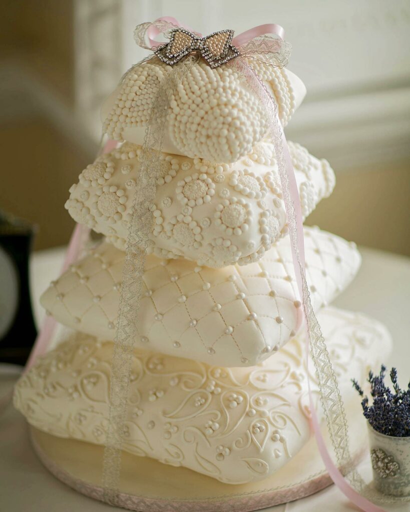 Wedding cake adorned with pearls and delicate lace details
