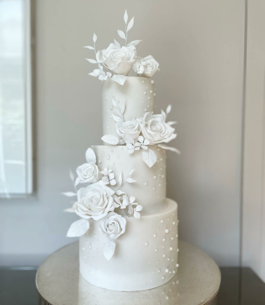 all white sugar flower and edible pearl and crystal wedding cake