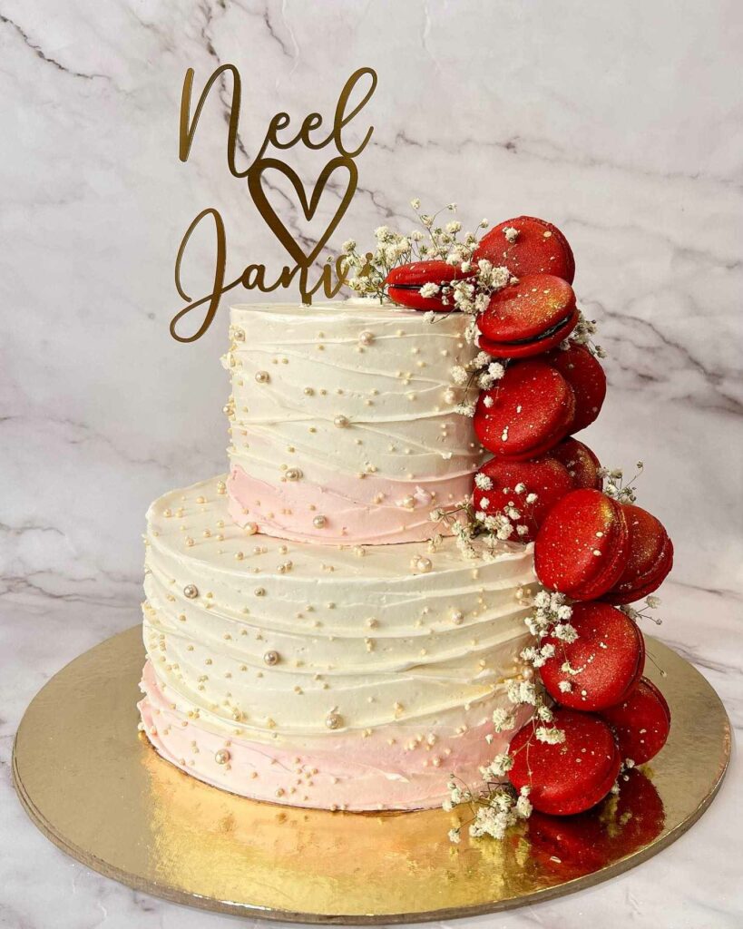 blush and ivory pearl wedding cake with red macarons