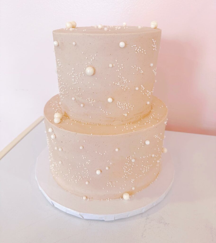 blush color pearl accent two tier wedding cake
