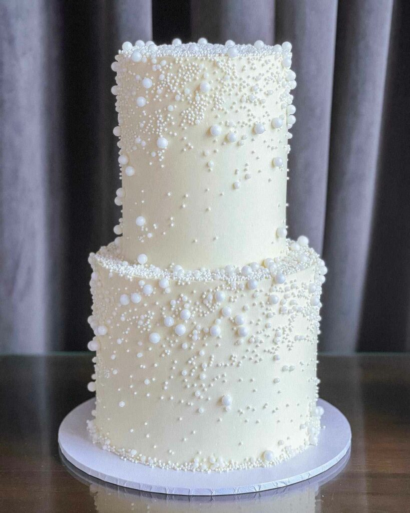 pearl adorned two tier wedding cake