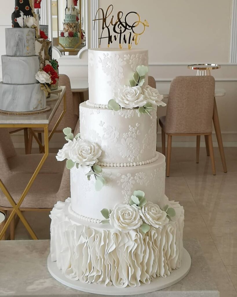 pearl and flowers with ruffle white wedding cake