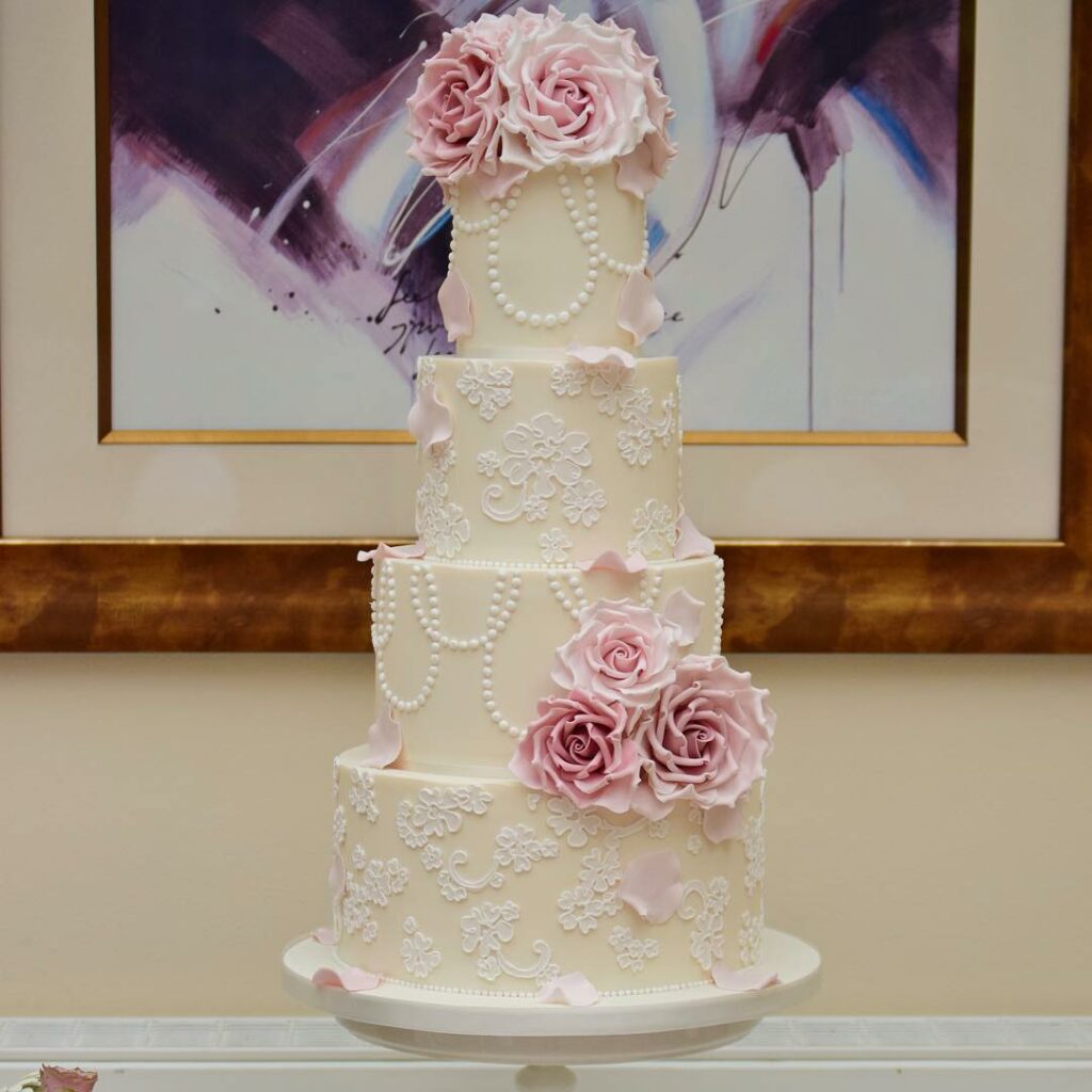 pearl ivory and blush wedding cake with flowers
