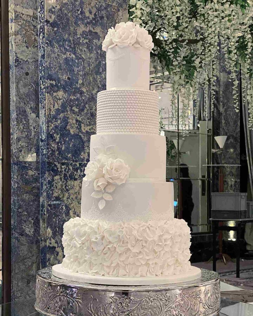 pearls and ruffle design wedding cake with sugar roses