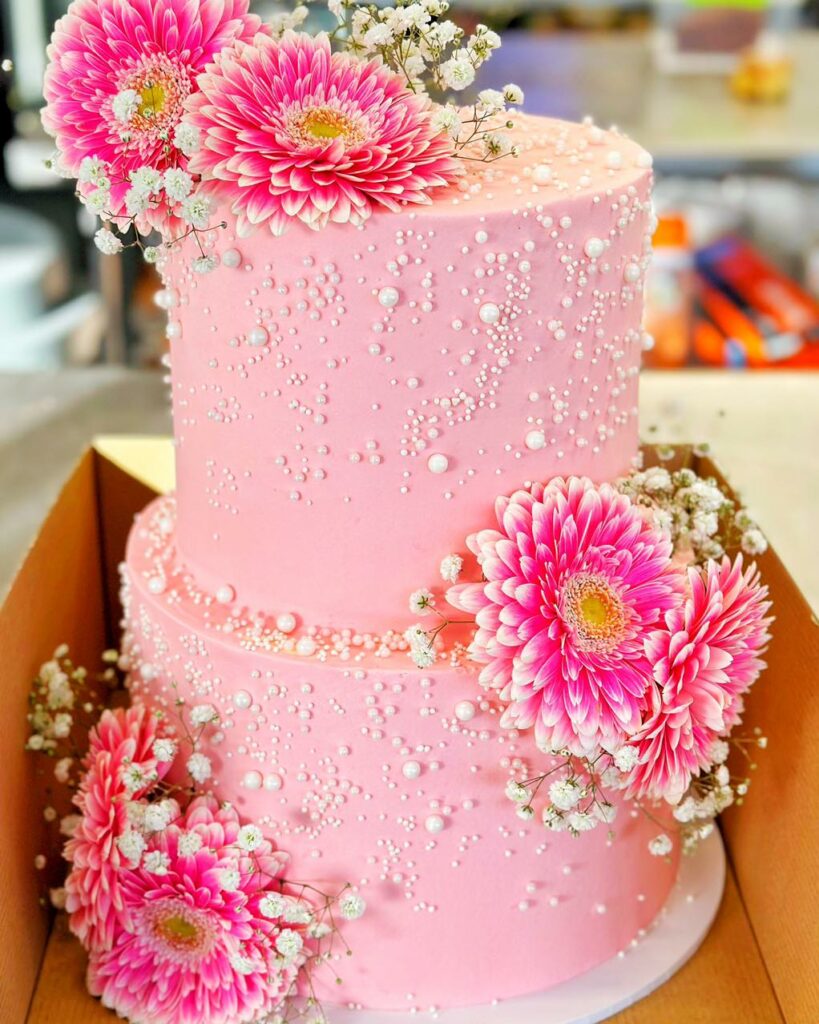 pink pearl and fresh flowers wedding cake with baby breath