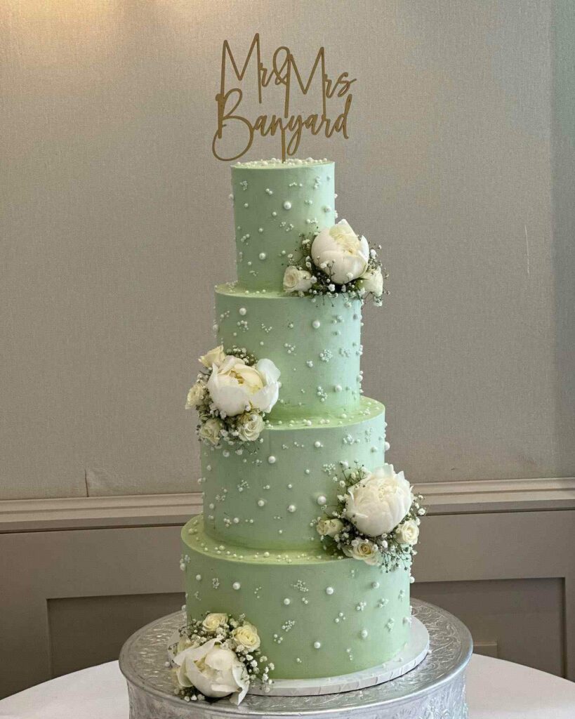 sage green with cake topper pearl tier wedding cake