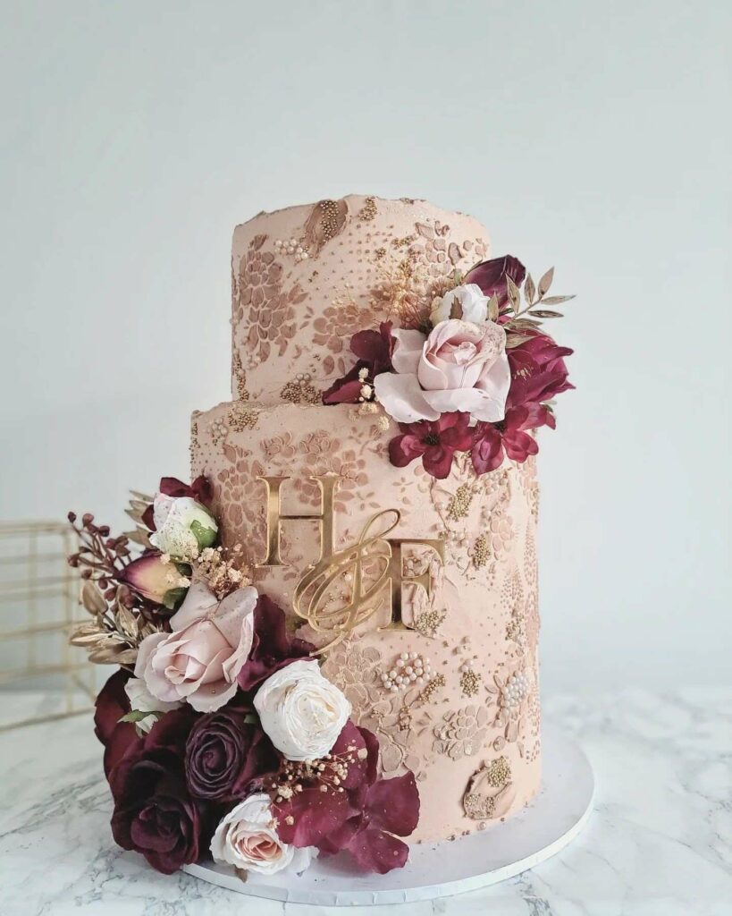 silk and dried flower blush and burgundy pearl wedding cake