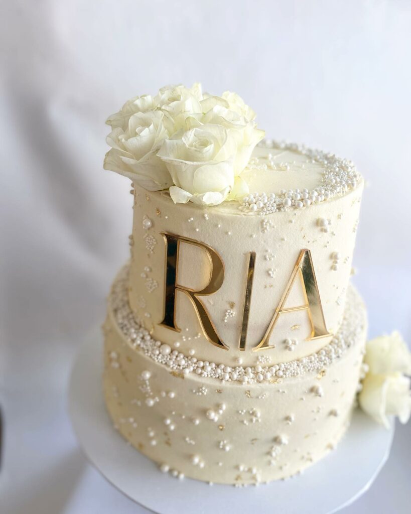 white and gold pearl themed wedding cake