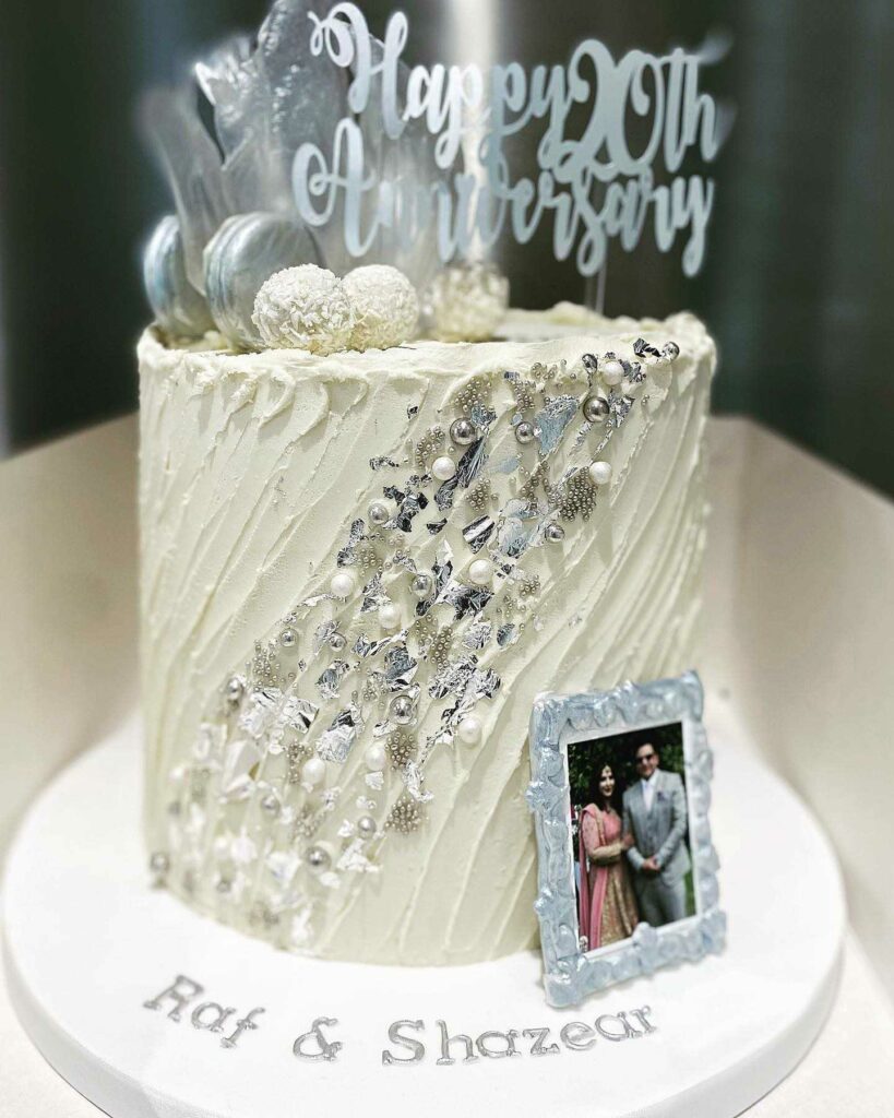 white and silver pearl wedding anniversary cake with topper