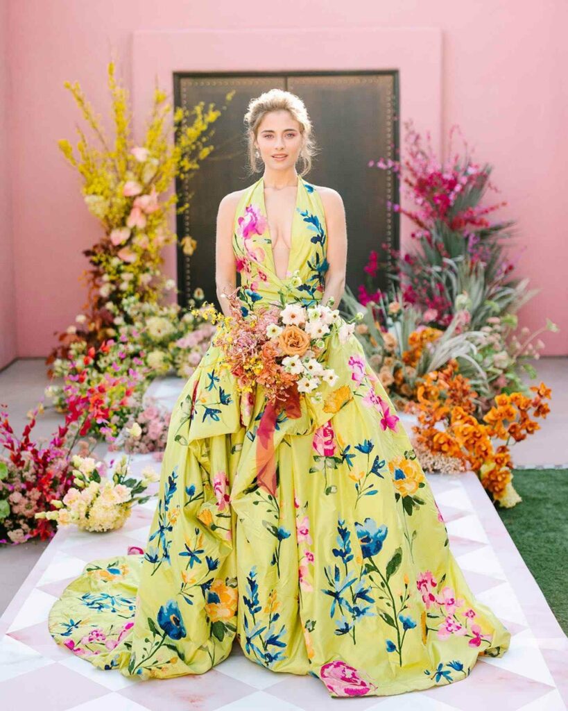 Embrace a vibrant celebration of love in this sun kissed yellow floral wedding dress blooming with romance and joy