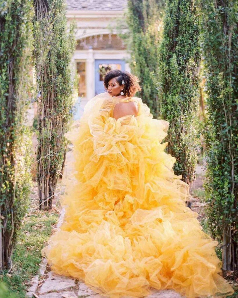 Embrace boldness with a vibrant cascade of golden yellow ruffles wedding dress a statement of joy and celebration