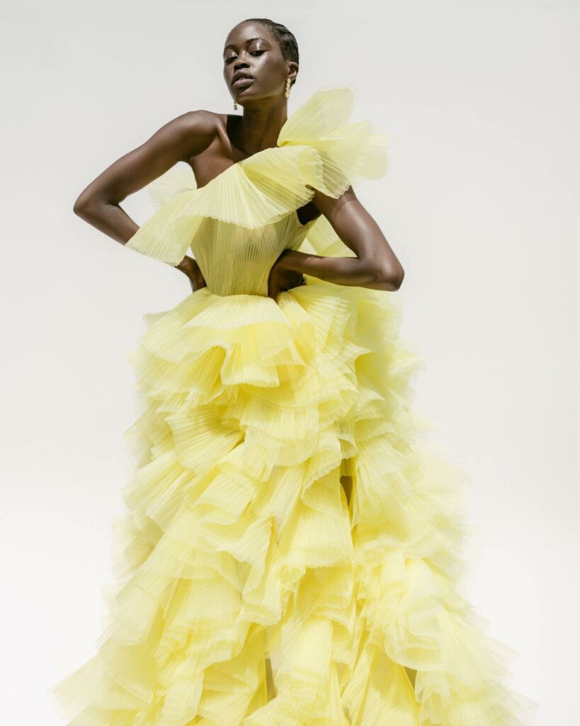 Layers of lemon chiffon whimsy cascade into bridal elegance sculpting a modern masterpiece of couture