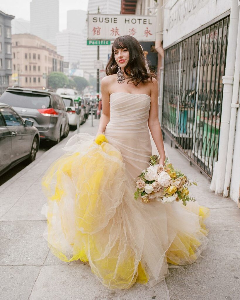 Strut down the aisle with a pop of playful yellow tulle infusing your wedding day with a touch of urban whimsy