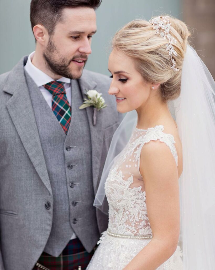 beautiful neckline wedding dress and high updo hairstyle with veil