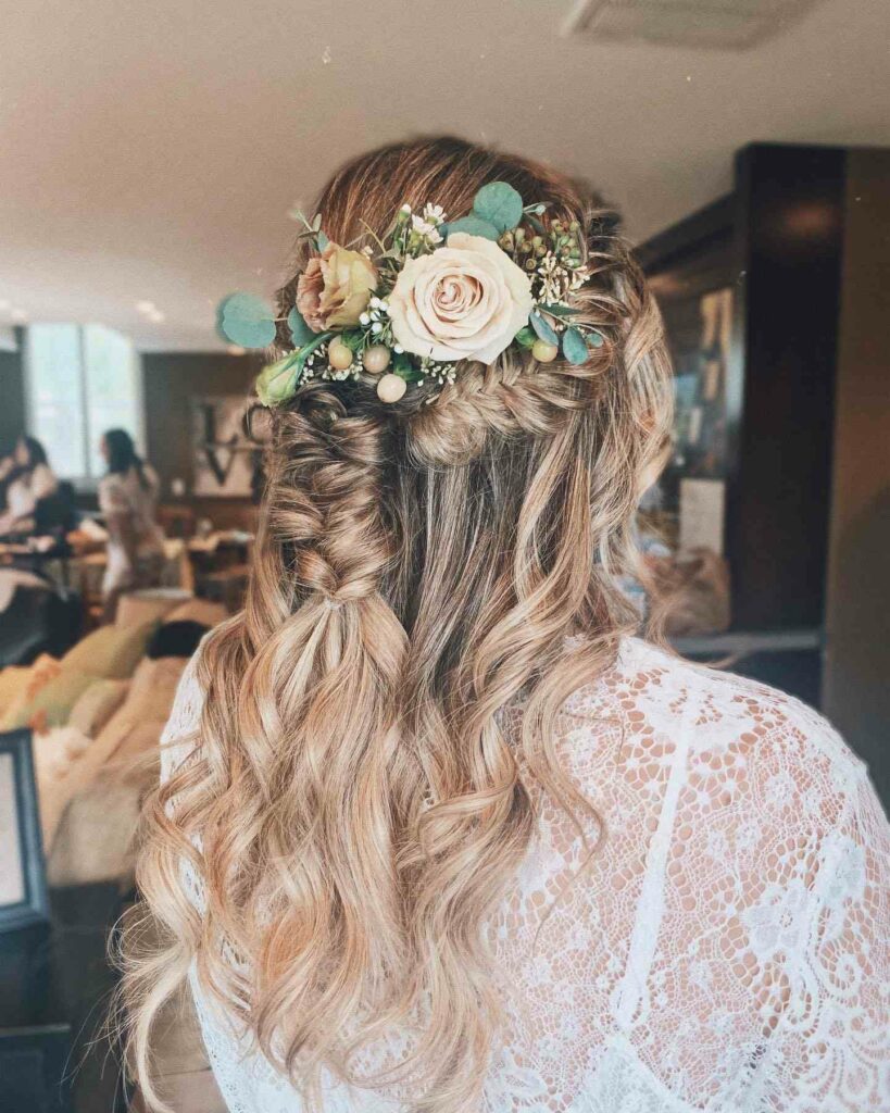 boho half up braided wedding hairstyle with beach waves and fresh flowers