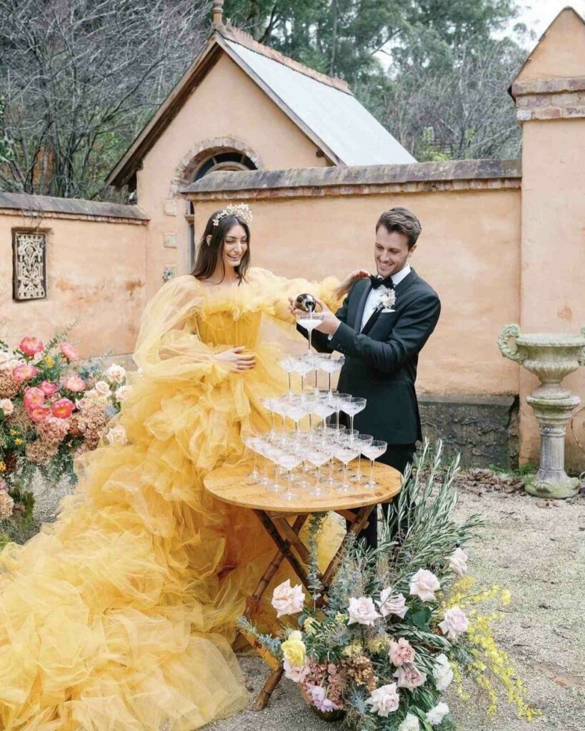 bride with yellow tulle wedding dress and champagne tower