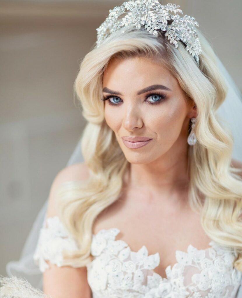 cascading platinum blonde waves hair down wedding hairstyle with veils and tiara