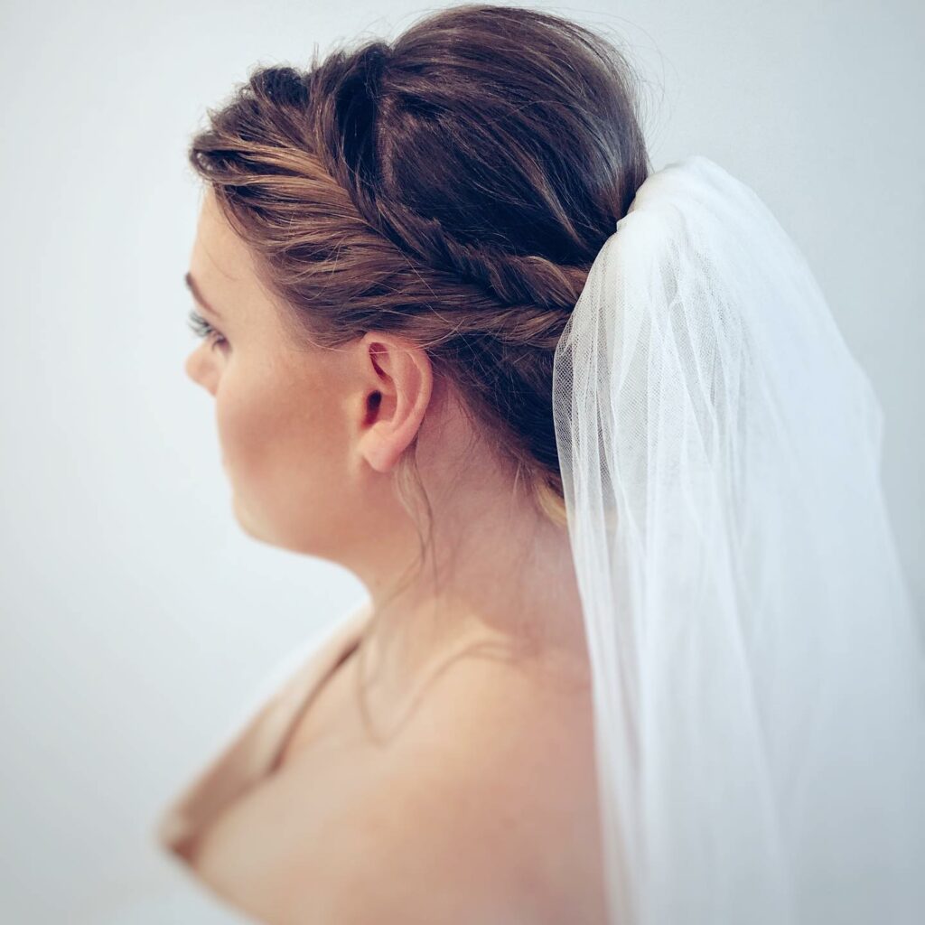 fishtail braided updo bridal hairstyle with veil