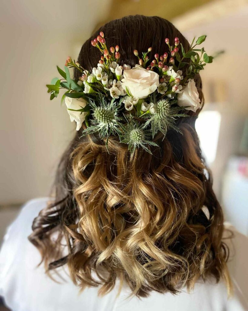 half up bridesmaid hairstyle with fresh flowers for woodland wedding theme